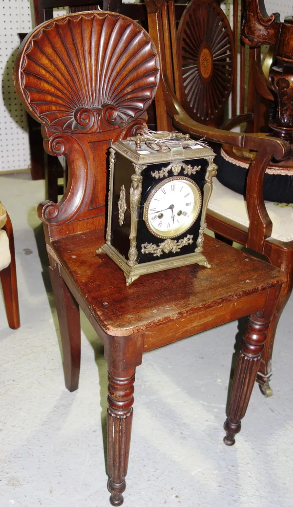 A Victorian mahogany hall chair, and an ebonised and metal mounted mantel clock (2).  D4