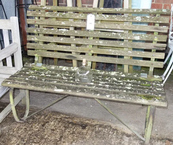 A wooden garden bench on iron frame. OUT