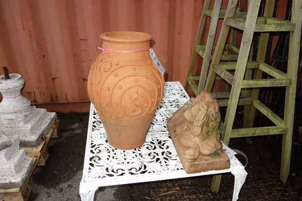 An ovoid terracotta vase, a terracotta figure of a recumbent lion and a horses head. (3)  OUT