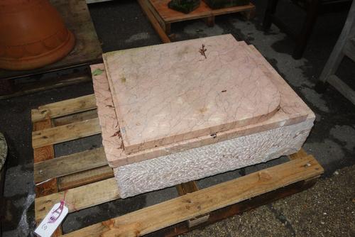 A pink veined marble pedestal sink.  OUT