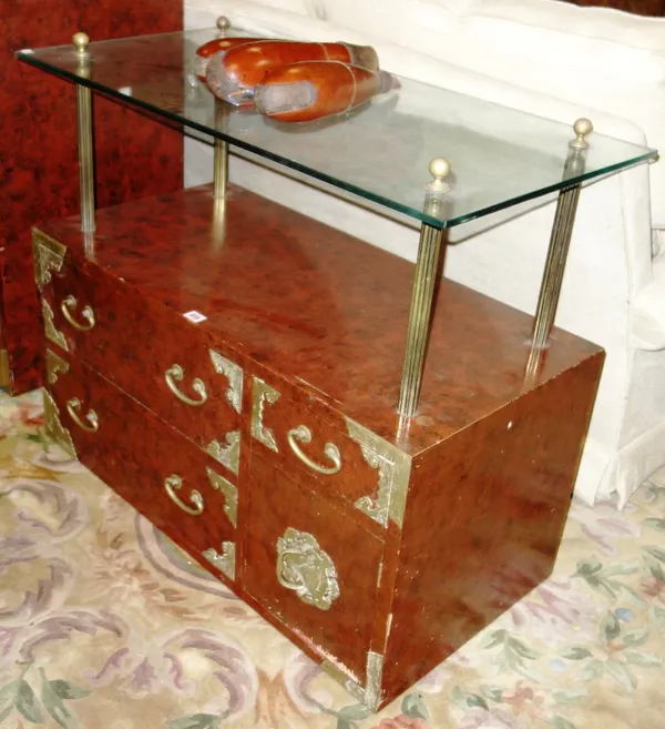 A 20th century Korean engraved brass red lacquered side cabinet with glass shelf over four drawers, 92cm wide.  DIS