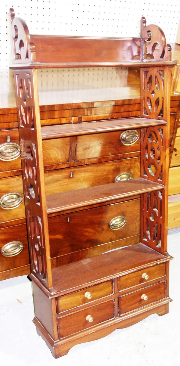 A hardwood floor standing set of four open shelves over four short drawers, with fret pierced sides, 52cm wide  G1