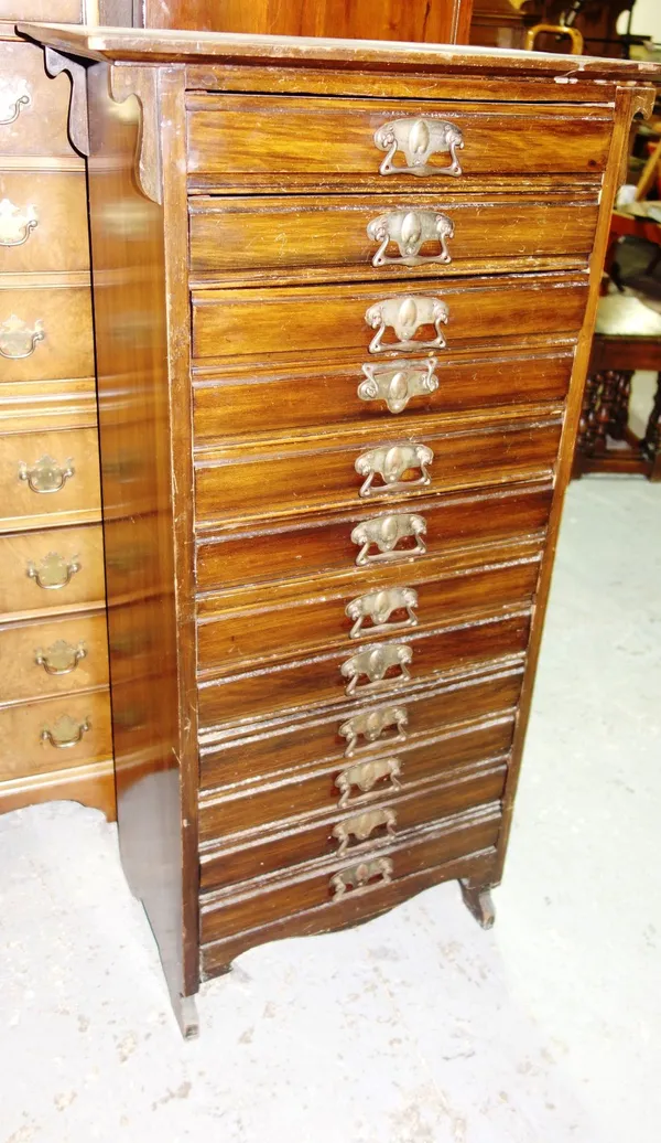 An early 20th century walnut music cabinet, with twelve drop front drawers, 61cm wide.  M8