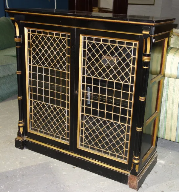 An ebonised and gilt side cabinet of Arts and Crafts design, 106cm wide. L4