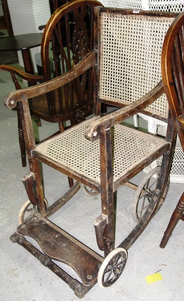 An Old Wardway wheelchair, with cane seat.    C5