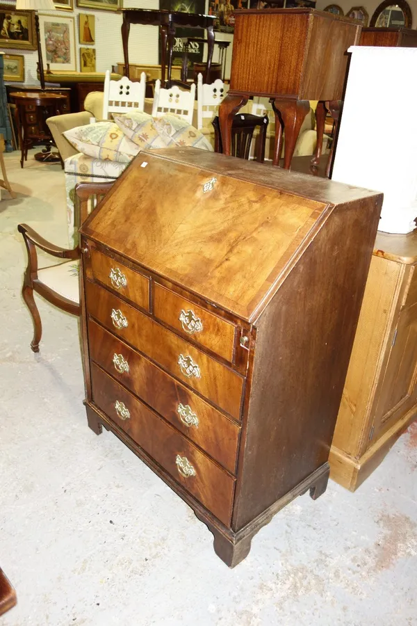 An Edwardian mahogany bureau with fitted interior and four long drawers, 76cm wide.   L1
