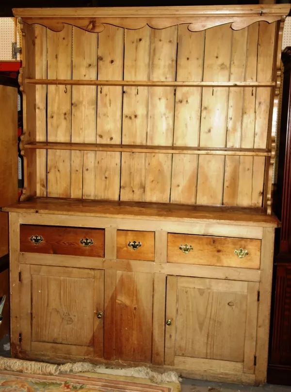 A Victorian pine dresser base with later plate rack. DIS
