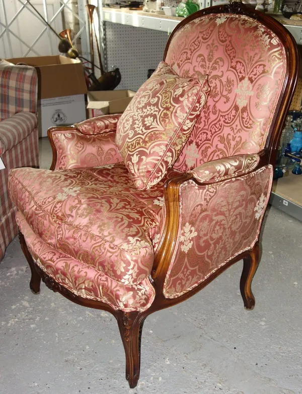 A 20th century walnut framed pink silk upholstered armchair.  C8