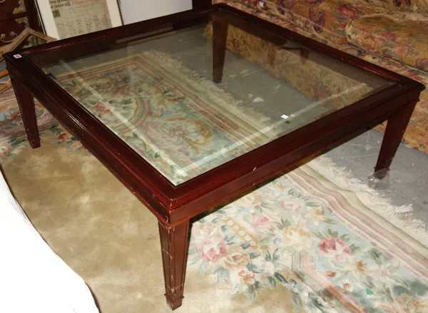 A 20th century square mahogany and glass coffee table. DIS