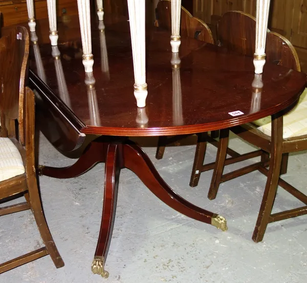 A large 20th century oval mahogany drop flap dining table.