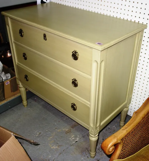 A 20th century pale green chest of three long drawers on turned fluted supports. GAL
