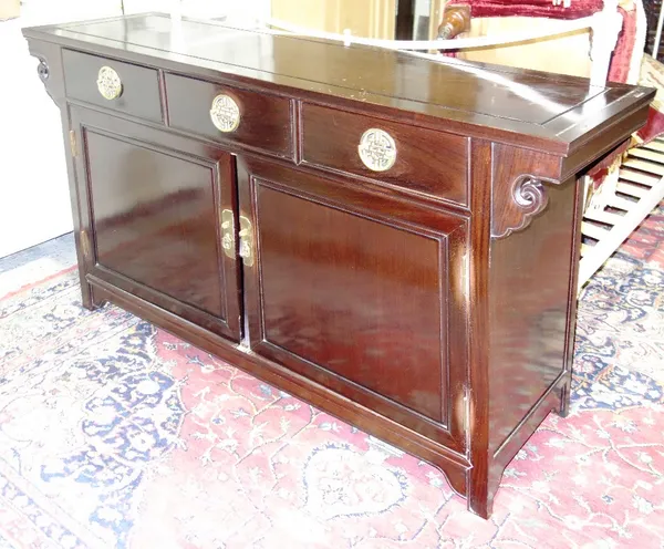 A Chinese lacquered sideboard with three drawers and pair of cupboards, 89cm wide.   J5