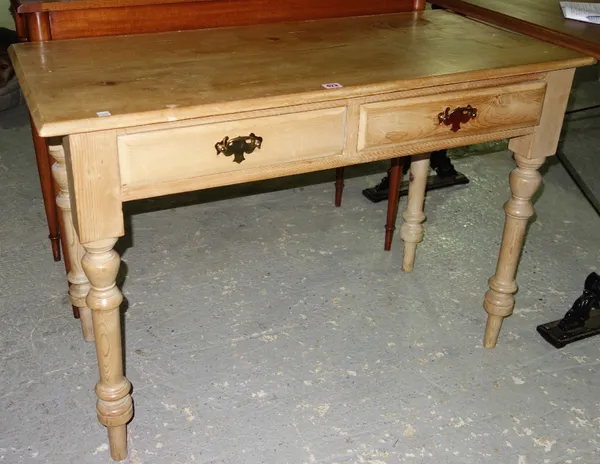 A 20th century pine two drawer writing table, 107cm wide.   H8