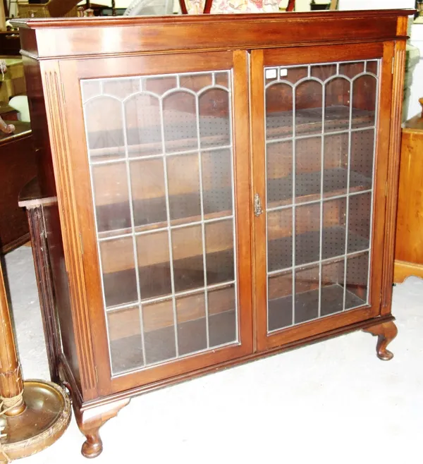A mid 20th century mahogany floor standing display cabinet, with pair of leaded glazed doors on pad feet, 120cm wide.  C1