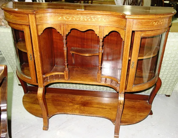 A late Victorian marquetry inlaid kidney shaped side cabinet, with glazed rounded corners, 133cm wide, together with a three tier drinks trolley, 68cm