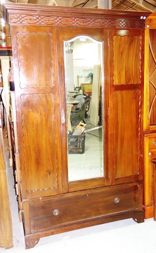 A late Victorian mahogany wardrobe, with mirrored door and drawer base, 126cm wide.   J8