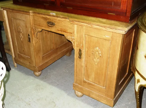 An oak and pine pedestal desk, with central drawer flanked by cupboards, 130cm wide.  D5