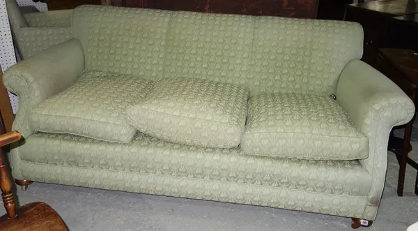 A 20th century three seat sofa with roll over arms, on bun feet, 205cm wide, 77cm high, 110cm deep.   C3
