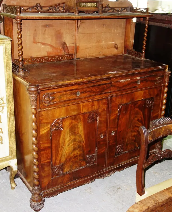 A Victorian mahogany framed chiffonier, the ledge back with carved and pierced gallery, over a pair of drawers and panel cupboards, flanked by split b