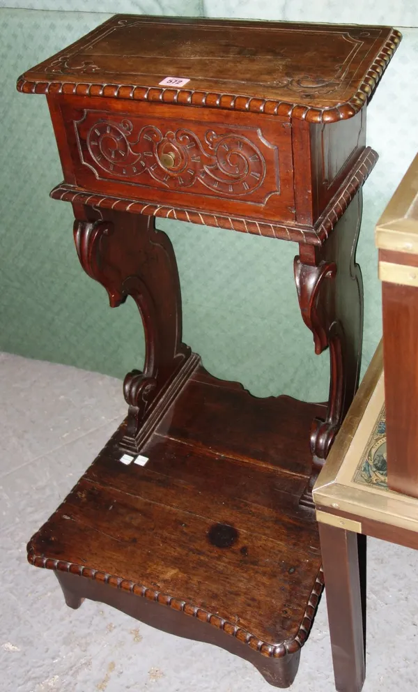 A 19th century walnut prayer stand with carved decoration. L4