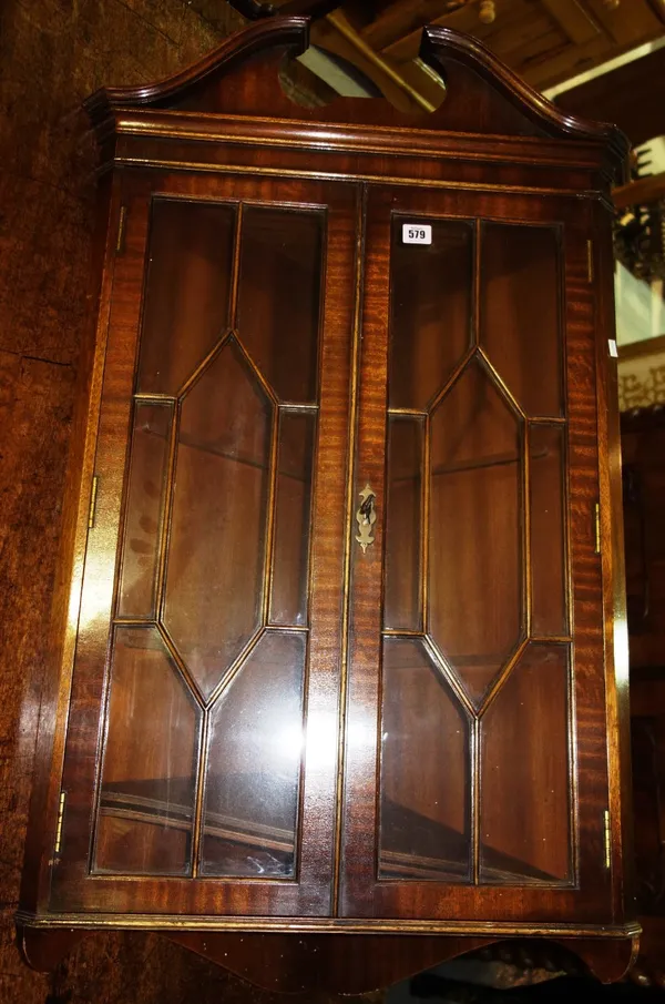 A 20th century mahogany glazed hanging corner cabinet.  G5