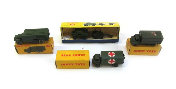 Four Dinky die-cast military vehicles, comprising; 677 armored command vehicle, 697 twenty five pounder field gun set, 621 three ton army wagon, and 6