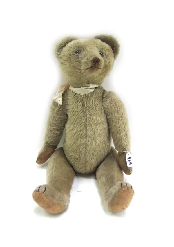 A Steiff musical teddy bear, 20th century, with golden fur, glass eyes and jointed limbs, 53cm high.