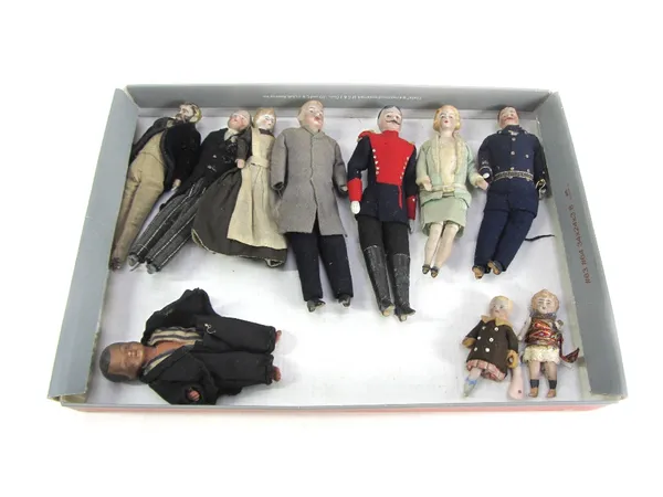 Ten small bisque porcelain dolls, circa 1900, probably German, comprising a family group and associated waiting staff, the tallest 17.5cm high (10).