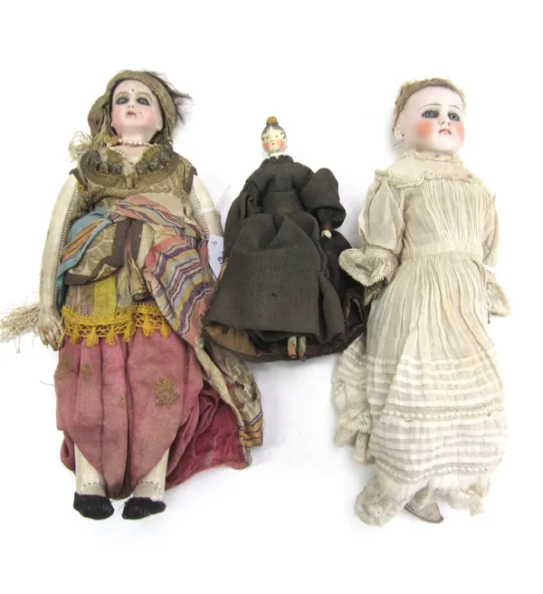 Two bisque porcelain dolls, circa 1900, probably German, unmarked, both with stuffed leather bodies, 25cm long, together with a late 19th century peg