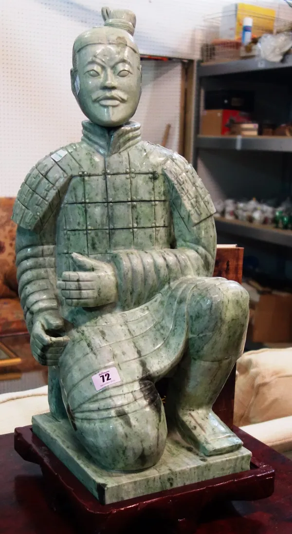 A 20th century pale green carved marble model of an eastern soldier. DIS