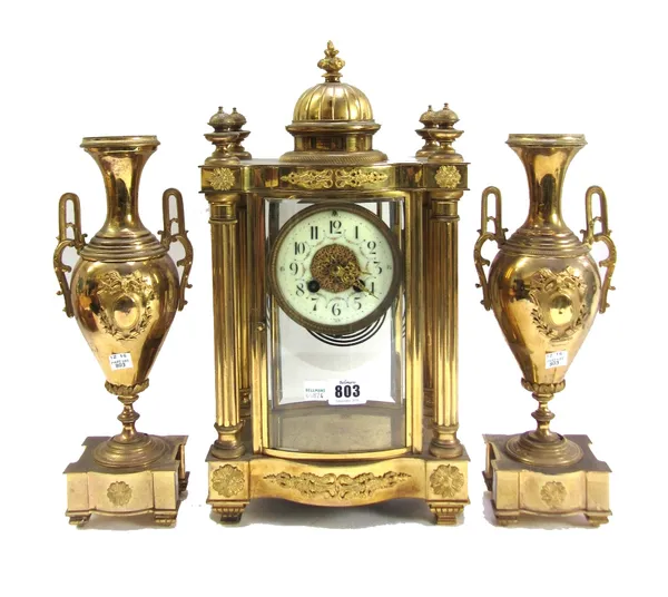 A French gilt brass four-glass mantel clock garniture, late 19th/early 20th century, with dome surmount and four pillared case, an enamel dial and two