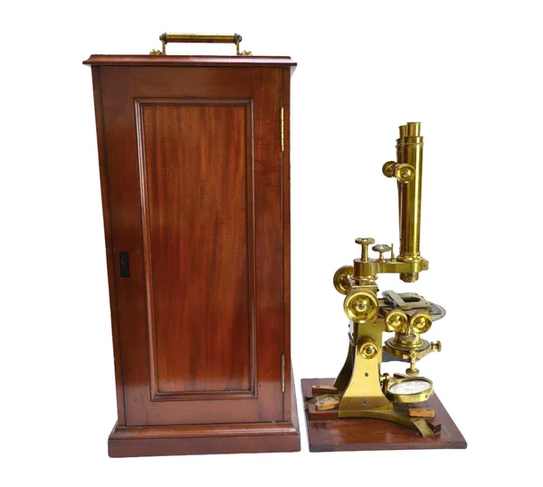 A brass binocular microscope by Edmund Wheeler, London, late 19th century, with various fine adjustments, rack and pinion focusing, rotating stage and
