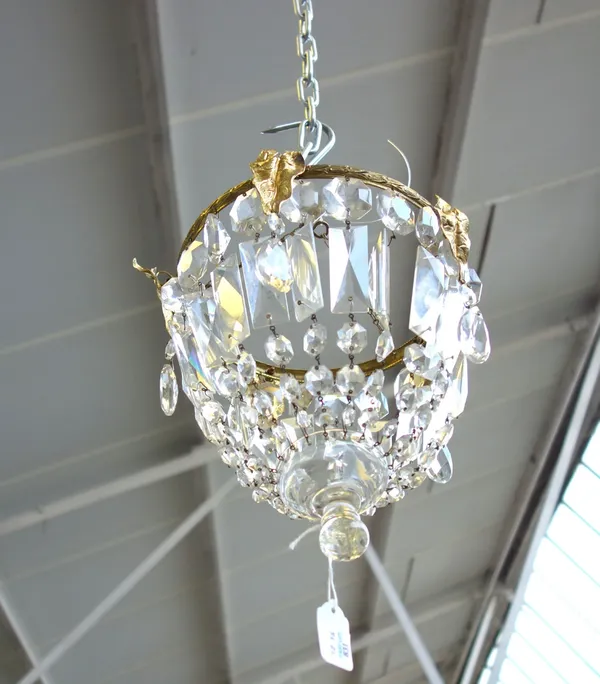 A three tier brass and cut glass bag chandelier, 20th century, hung with cut glass prisms over three graduated circular tiers, 37cm high, and two furt