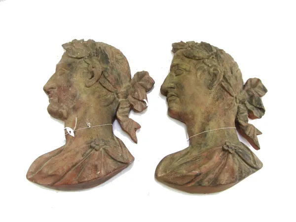 A pair of modern plaster classical profile busts painted in imitation of terracotta, each depicting a Romanesque male with toga and laurel wreath, 44c
