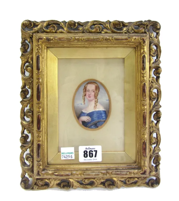 A late 19th century portrait miniature on ivory depicting a lady in a blue silk dress, housed in a gilt gesso carved wood frame, the miniature 7cm hig