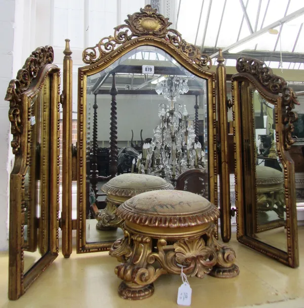 A giltwood carved and pierced triptych dressing table mirror, with bevelled glass hinged panels, 66cm high, and a small giltwood carved footstool, wit