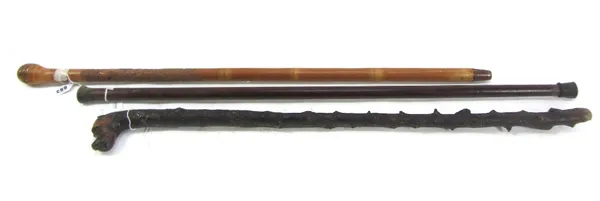 A Japanese bamboo walking stick, 20th century, finely carved and depicting the Japanese folk tale 'Nezumi no sumo', signed, 90.5cm long, and two furth