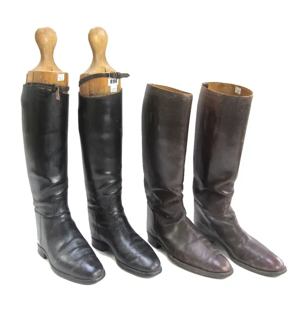 A pair of black leather riding boots and wooden lasts, and a further pair of size 10 brown leather riding boots (4).
