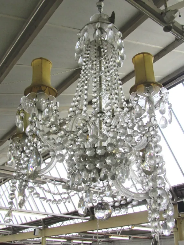 A six branch glass chandelier, 20th century, the domed finial over a baluster stem issuing six swan neck branches festooned with cut glass drops, (a.f