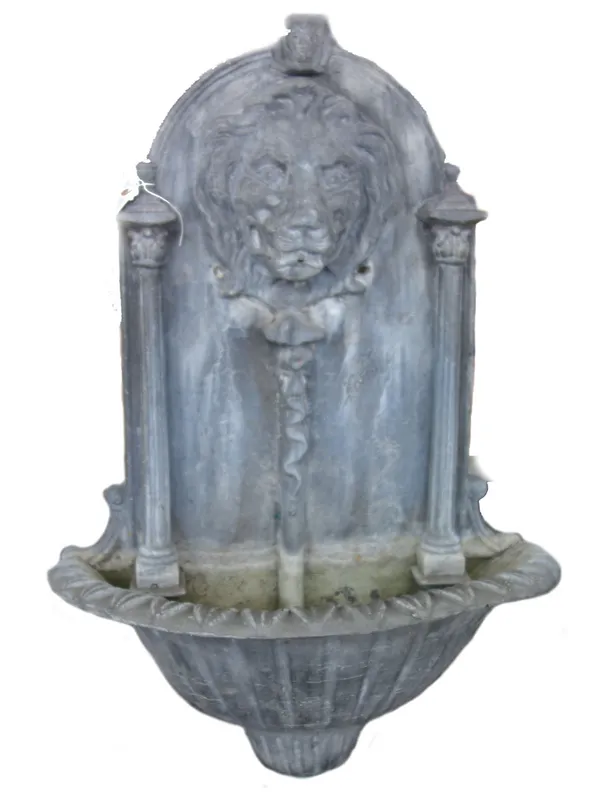 A modern lead water stoop, the relief cast lion mask flanked by Corinthian type pillars, with a fluted half bowl base, 75cm high. Property from the es