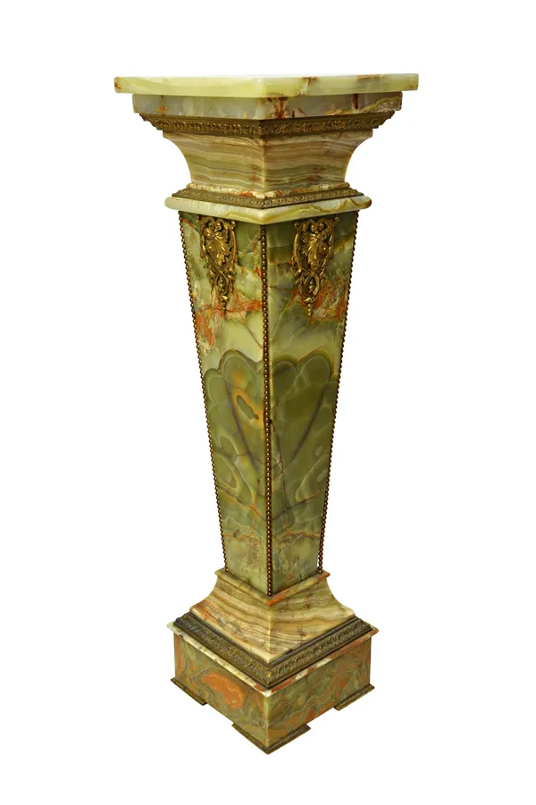 A green onyx and ormolu pedestal of square tapering form, c.1900, with foliate and banded ormolu embellishments, 115cm high.  216  Illustrated