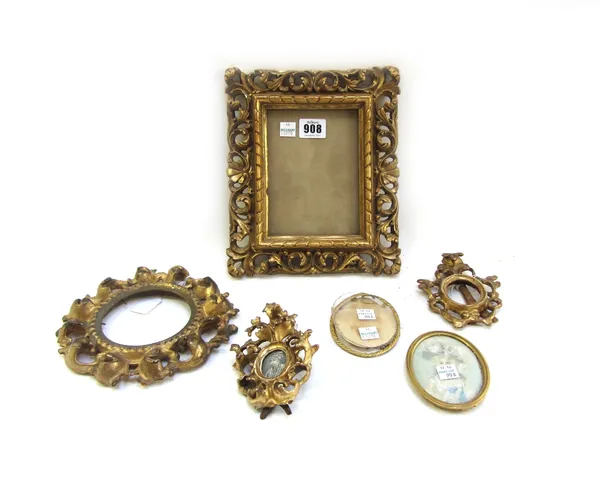 A collection of carved Florentine picture frames, including; a rectangular frame, an oval frame and two small oval frames, all carved in the Rococo st