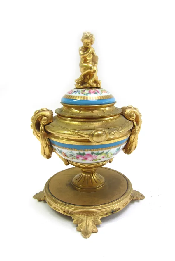 An early 20th century gilt bronze Sevres style porcelain lidded inkwell, the cover surmounted by a seated putti figure, 13.5cm high.  22