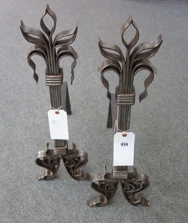 A pair of steel andirons of stylised fleur-de-lys form, 67.5cm high (2).