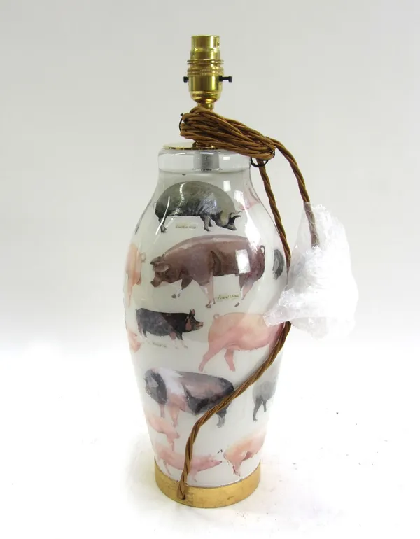 A modern decalcomania glass table lamp of ovoid form, decorated with pigs, 34cm high.