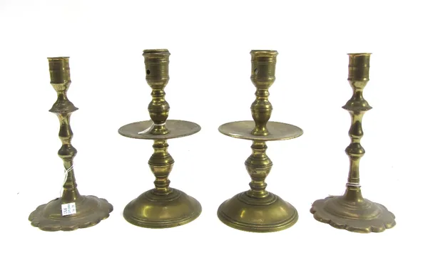 A pair of 18th century Dutch brass baluster candlesticks with circular domed base, 21cm high, and a pair of early Queen Anne brass baluster candlestic