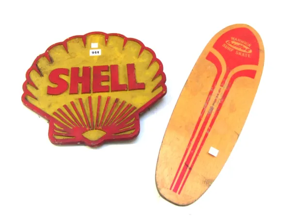 A vintage painted metal 'Shell' automobilia sign, 36cm wide, and a Warwick 'bullet' skateboard, 59cm (2).