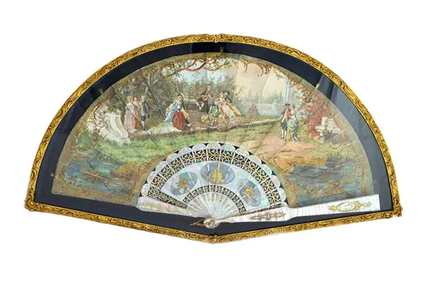 A 19th century Continental painted paper fan, detailed with Victorian figures against a landscape, the gilt and foliate pierced mother of pearl sticks