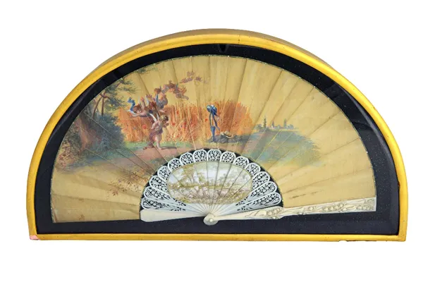 A late 19th century Continental painted silk fan, detailed with Cupid and cherubs against a landscape, indistinctly signed, the foliate carved ivory s