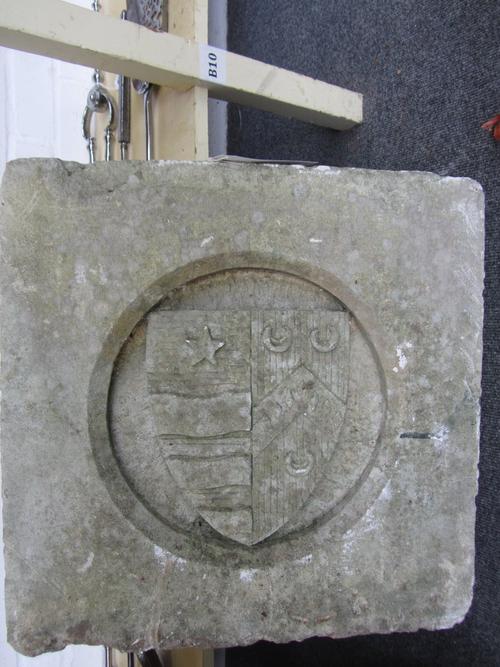 Two reconstituted stone armorial plaques, each of square section, one centred with a shield bearing a family crest, the other with a capital 'W', 52cm